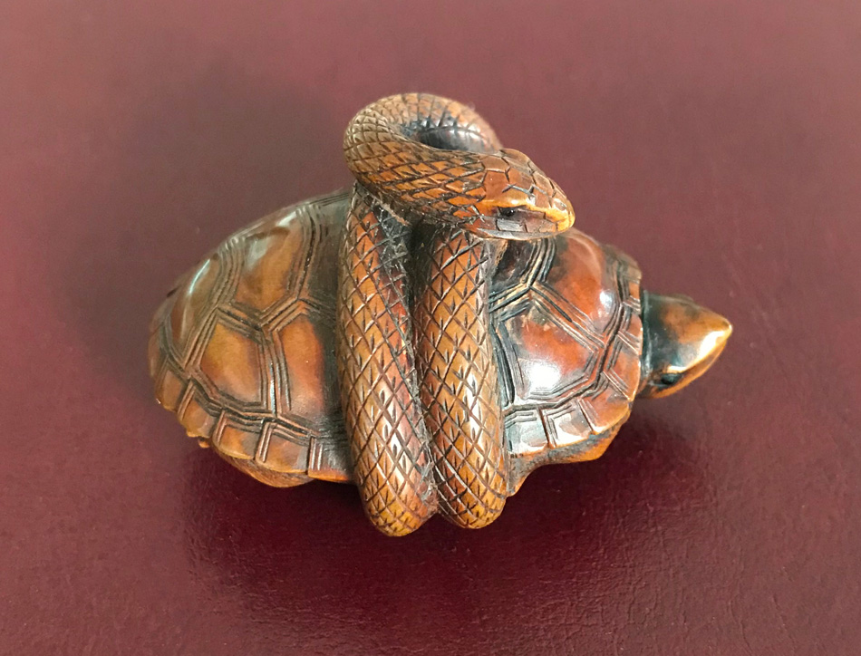 Netsuke of a snake wrapped around a tortoise